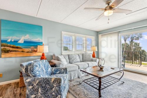 a living room with a couch and a table at N1 Amelia South apts in Fernandina Beach