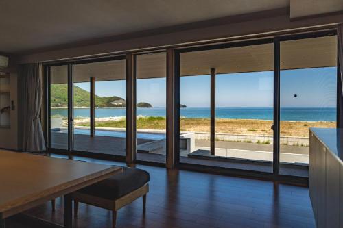 a living room with a view of the ocean at SETO CLAS TSUDA THE Beach RESORT B in Yoshimi