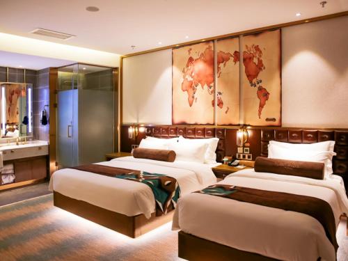 a hotel room with three beds and a bathroom at James Joyce Coffetel Shijiazhuang Wanda Plaza Tangu Metro Station in Shijiazhuang