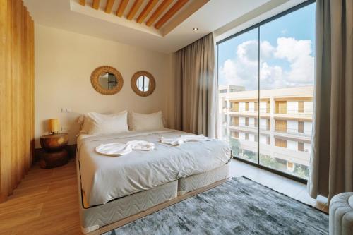 a bedroom with a bed and a large window at Luxury Pool View Suite at 5-Star Hotel in Punta Cana