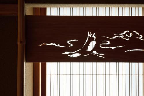 a carving of a dragon on a wooden wall at unsui 武雄蓬莱町 雲水 in Takeo