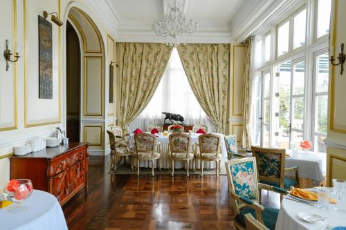 a dining room with a table and chairs at Dalat Palace Heritage Hotel in Da Lat