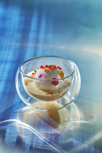 a glass bowl filled with ice cream on a table at The Landis Taipei in Taipei
