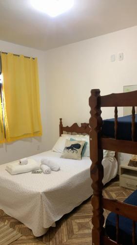 a bedroom with a bed with towels on it at Wonders of Arraial Loft 7 in Arraial do Cabo