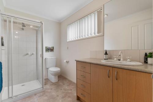 a bathroom with a shower and a toilet and a sink at Rosebud Family Retreat in Rosebud
