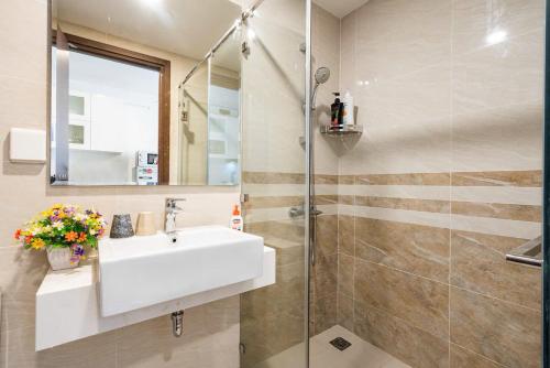 a bathroom with a sink and a shower at Stylist Studio Saigon Royal Hana Apart in Ho Chi Minh City