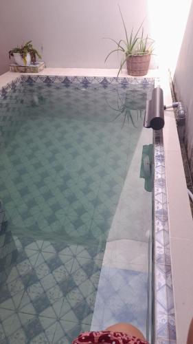 a swimming pool in a house with at Fatimah Pancar View in Pasirkuda