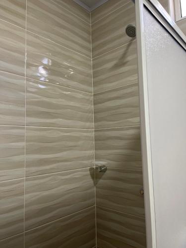 a shower stall with a glass door in a bathroom at Posada Three Cay Suites in Providencia