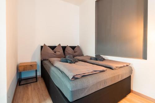 a bed sitting in a room with a mirror at Im Herzen von Bad Ischl #2 in Bad Ischl