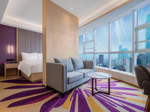a hotel room with a bed and a couch and a table at Lavande Hotel Changsha West Jiefang Road Furong Plaza in Changsha