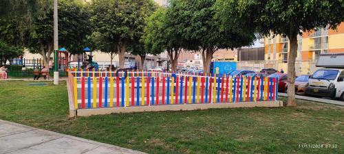 a colorful fence in front of a park at Pacific Apartamento Surco in Lima