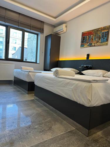 two beds in a room with twothirds of the room at Grand FM Hotel in Istanbul