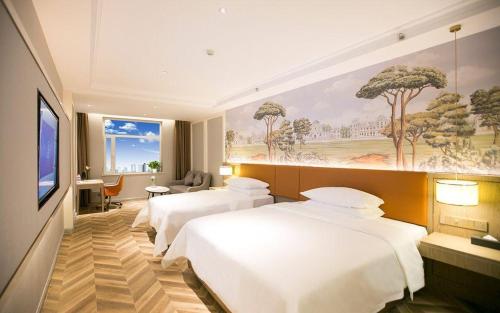 a hotel room with two beds and a flat screen tv at Vienna Hotel Jinan Beiyuan Street Red Star Macalline in Jinan