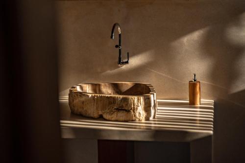 a sink with a faucet on top of a counter at Anna Villas by Sumba-Beach in Memboro