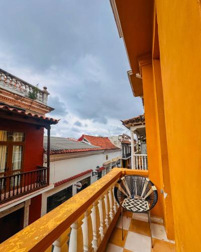a view from the balcony of a building with a chair at Hostal Casa Torres Centro Historico - Adults Only in Cartagena de Indias