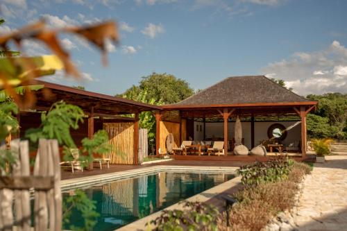 a house with a pool and a gazebo at Anna Villas by Sumba-Beach in Memboro