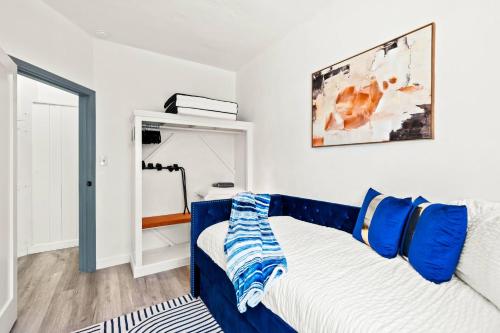 a bedroom with a bed with blue and white at 2BR Luxury Getaway Mins to Beach Arcade & Games in Manhattan Beach