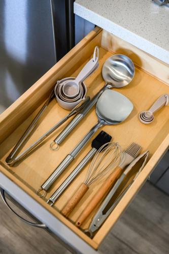 a wooden tray with utensils on a table at 2BR Luxury Getaway Mins to Beach Arcade & Games in Manhattan Beach