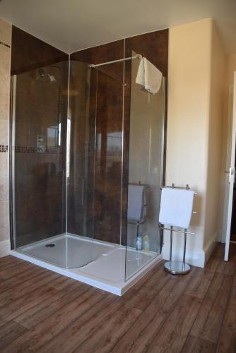 a shower with a glass enclosure in a room at Kingsleigh Guest House in Lowestoft