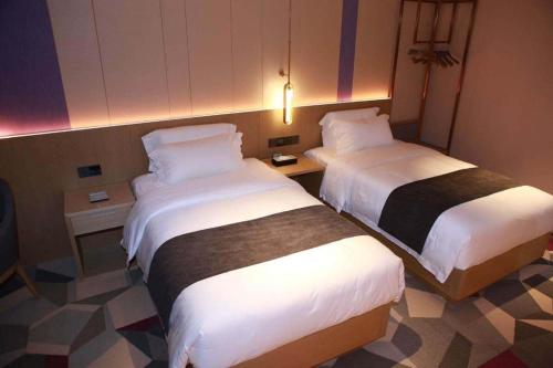 a hotel room with two beds in a room at Lavande Hotel Shenzhen East Gate Wanxiang City Guomao Metro Statipn in Shenzhen