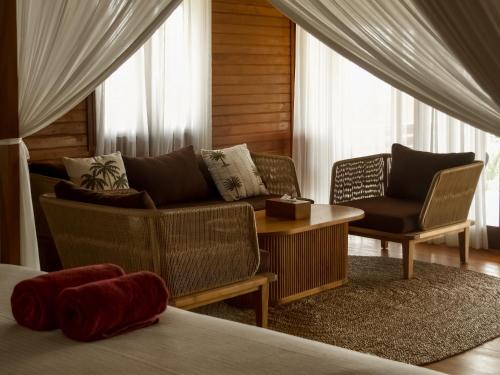 a living room with a couch and a chair at Anna Villas by Sumba-Beach in Memboro