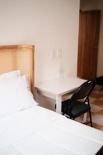 a bedroom with a desk and a bed and a chair at Hostal Casa Torres Centro Historico - Adults Only in Cartagena de Indias