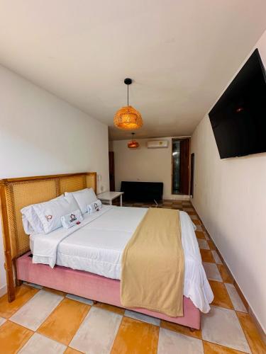 a bedroom with a bed and a flat screen tv at Hostal Casa Torres Centro Historico - Adults Only in Cartagena de Indias