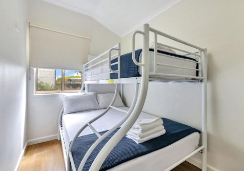 a small bedroom with a bunk bed and a bunk bed at Darwin FreeSpirit Resort in Darwin