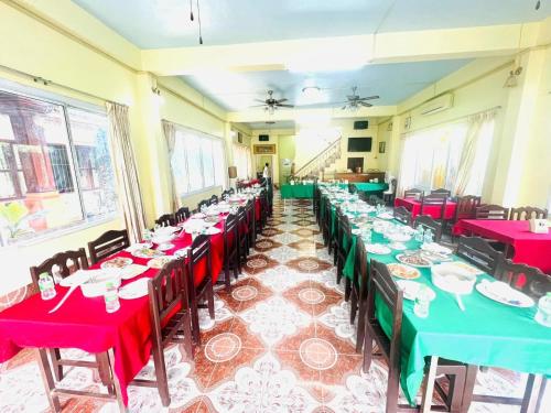 a room with tables with red and green tablecloths at Vang Vieng Khampaseuth Hotel in Vang Vieng
