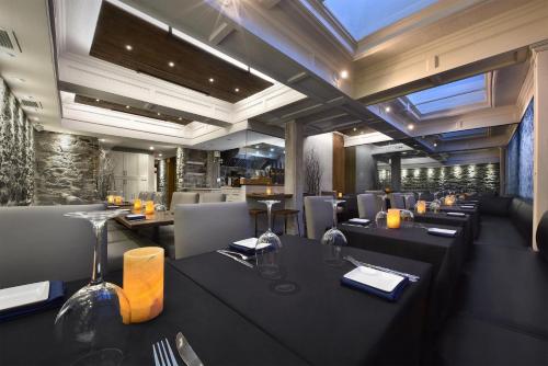 a restaurant with tables and chairs and a dining room at Hotel Épik Montréal in Montréal