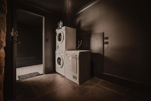 a laundry room with a washer and dryer at The Maple Lodge with Alpacas, Goats, Boars, Ducks & Chickens Farm Stay with Outdoor Pizza Oven in Robertson