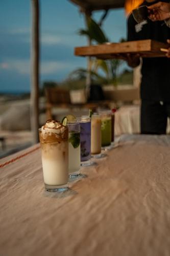 a row of drinks sitting on a table at Anna Villas by Sumba-Beach in Memboro