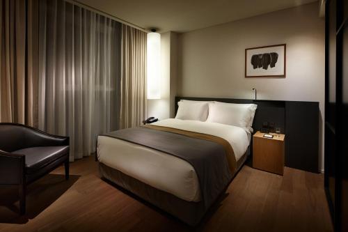 a hotel room with a bed and a chair at Shilla Stay Seocho Gangnam Station in Seoul
