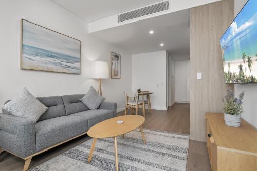 a living room with a couch and a table at Chic Studio Stay Near Cafés and Coastline in North Fremantle