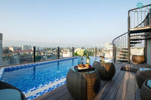 a balcony with a swimming pool on a building at Solare De Monte Hotel & Spa in Hanoi