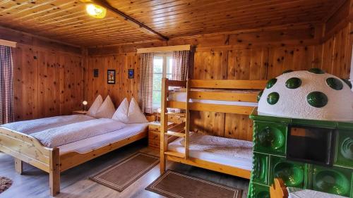 a bedroom with two bunk beds in a cabin at Berghotel Breitmoos in Mittersill