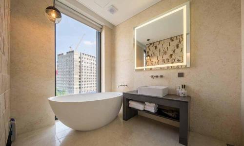 a bathroom with a large tub and a large window at Dobong Hotel Bay204 in Seoul