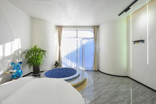 a bedroom with a bed and a large window at Hidden Lodge Xiaoyin B&B in Xizhuang