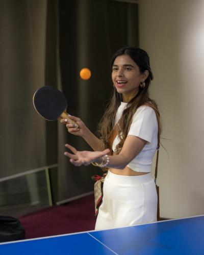 a woman is holding a ping pong racket at Marriott Suites Pune in Pune