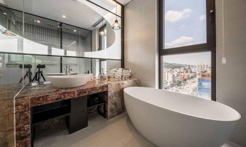 a bathroom with a large tub and a large window at Dobong Hotel Bay204 in Seoul