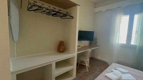 a bedroom with a desk and a bed and a window at Koralis in Petra