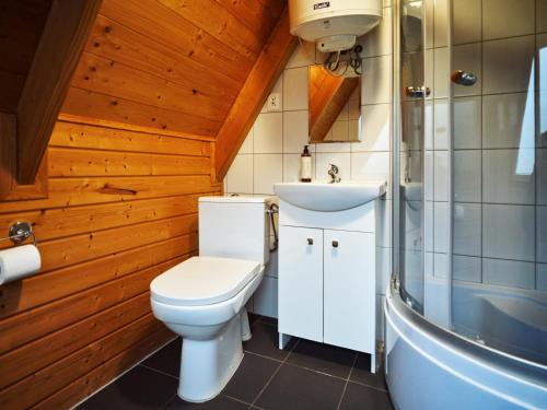 a bathroom with a toilet and a sink at Mholiday Sarbinowo u Kaspra in Sarbinowo