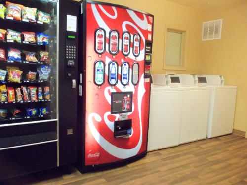 a cocacola soda vending machine in a store at DuPont Suites - Louisville in Louisville