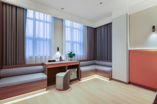 a hotel room with a desk and windows at Chengdu Haotian Guotai Hotel in Chengdu