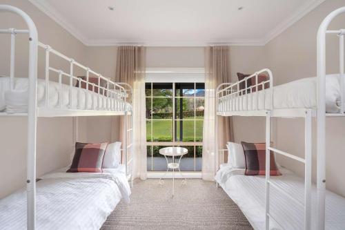 two bunk beds in a room with a window at Westbrook, Kangaroo Valley in Kangaroo Valley