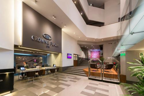 a lobby of a store with chairs and tables at Crowne Plaza Lima by IHG in Lima