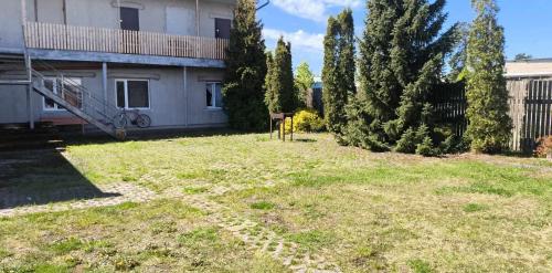an empty yard in front of a house at Vieta tavai atputai ar grilu in Liepāja