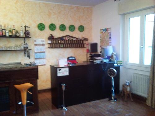 a room with a bar with a dog standing in the room at Hotel Bristol in Sesto San Giovanni