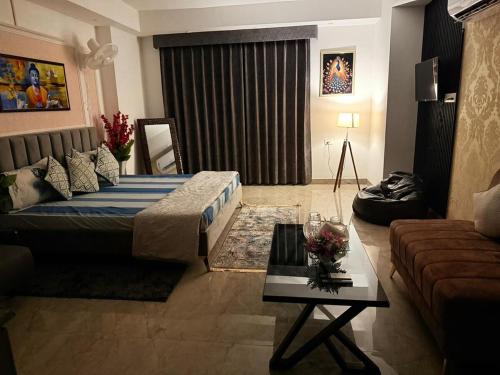 a living room with a bed and a couch at The Escape of Paradise in Zirakpur