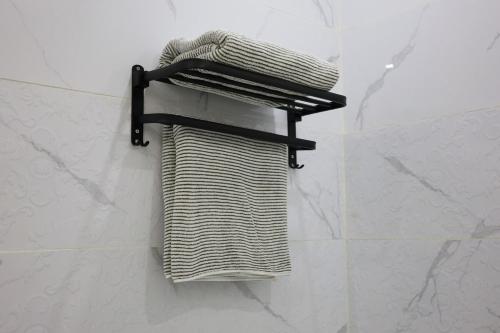 a towel rack on the wall of a bathroom at A spacious apartment with a full kitchen in Al Madinah